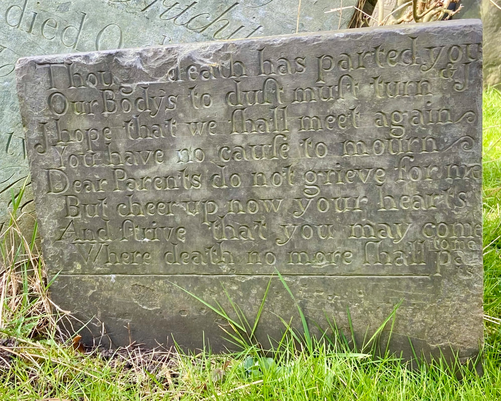 Photograph of the oldest headstone in All Saints graveyard dated 1710